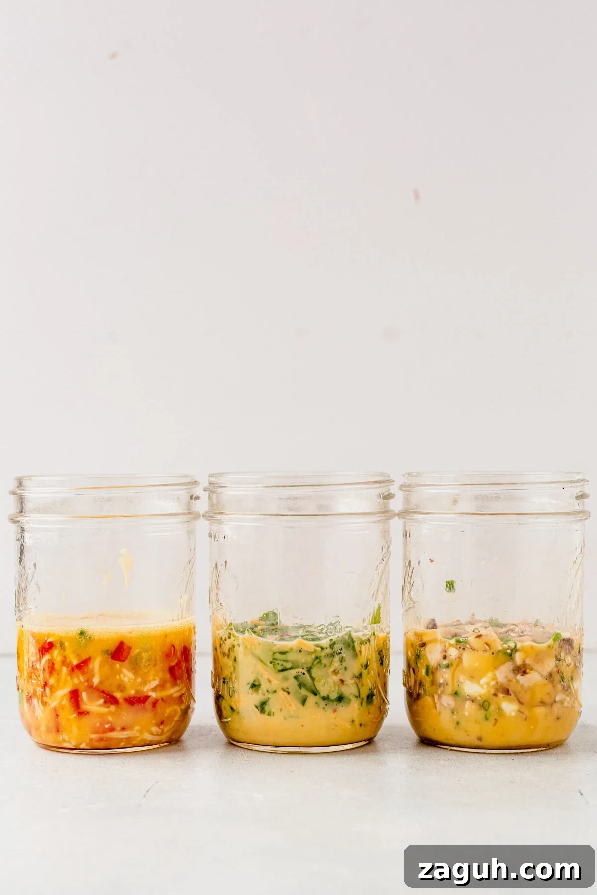 Perfectly Fluffy Scrambled Eggs in the Air Fryer 5 mason jars filled with veggies, cheese and eggs