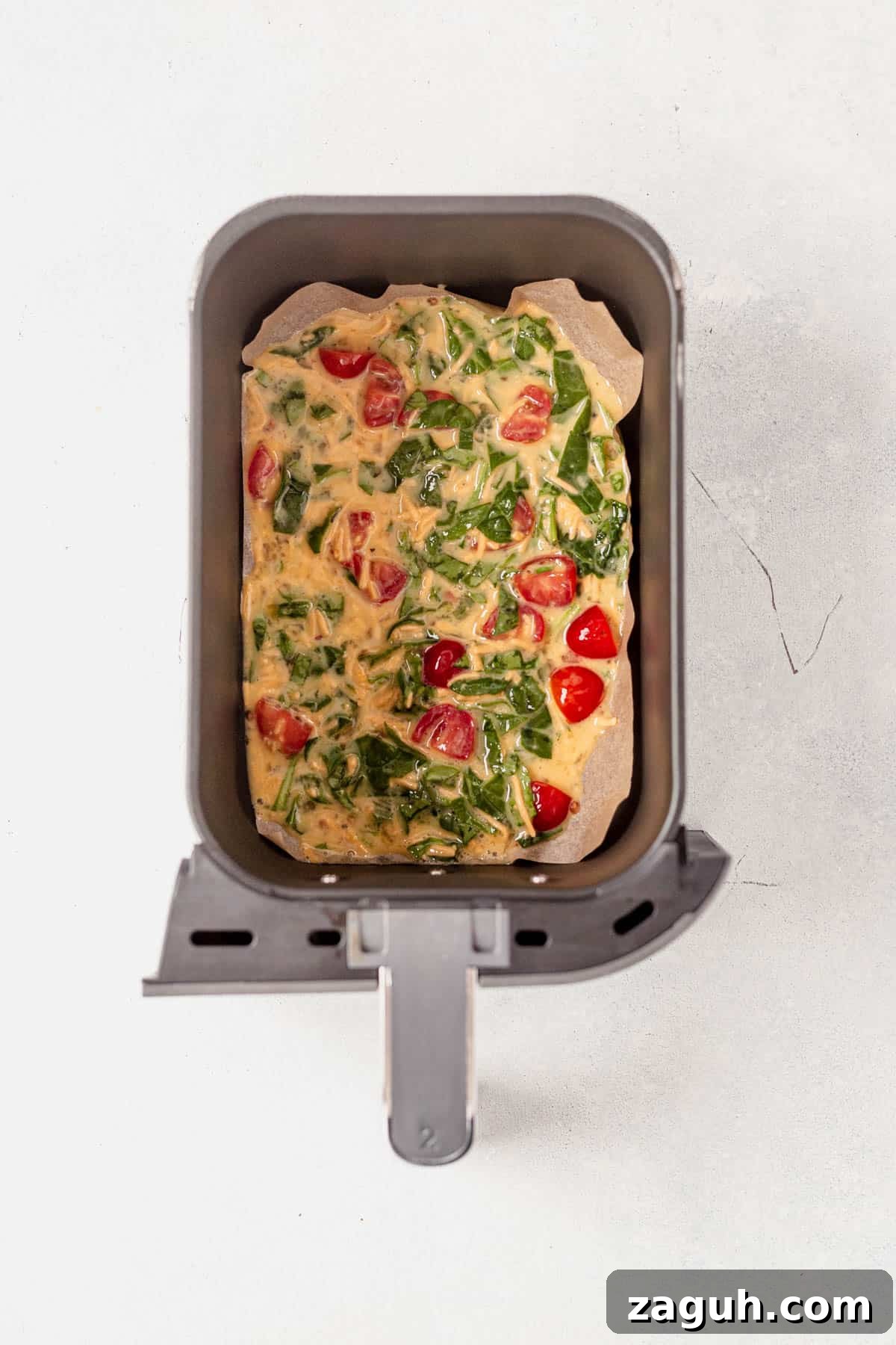 Perfectly Fluffy Scrambled Eggs in the Air Fryer 6 scrambled eggs in an air fryer basket