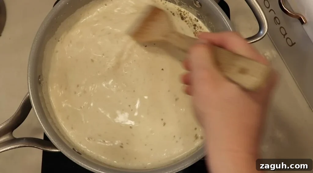 Creamy Garlic Sauce Recipe for Pasta, Chicken, and Veggies 12 Stirring pan