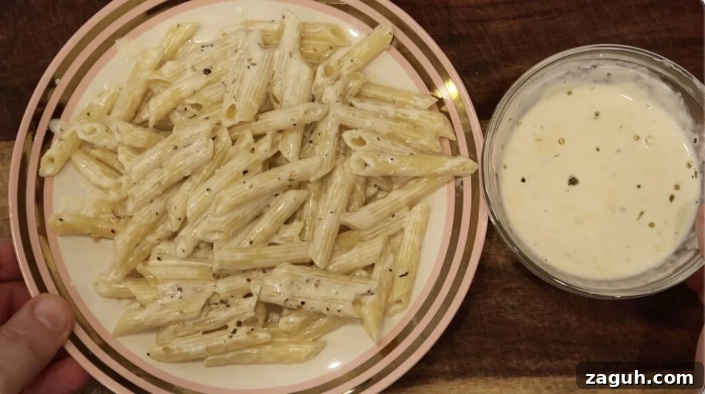 Creamy Garlic Sauce Recipe for Pasta, Chicken, and Veggies 18 Plate of pasta and bowl of sauce next to it