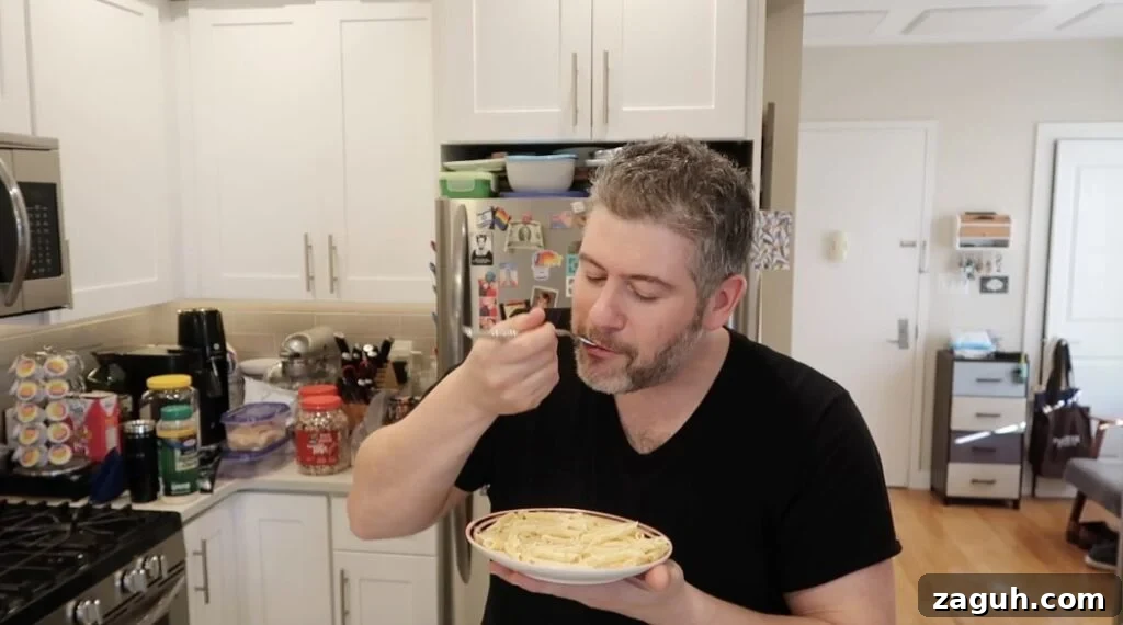 Creamy Garlic Sauce Recipe for Pasta, Chicken, and Veggies 19 Man trying sauce with pasta.