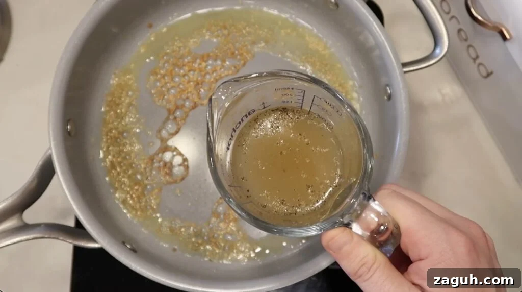 Creamy Garlic Sauce Recipe for Pasta, Chicken, and Veggies 7 Broth added to pan