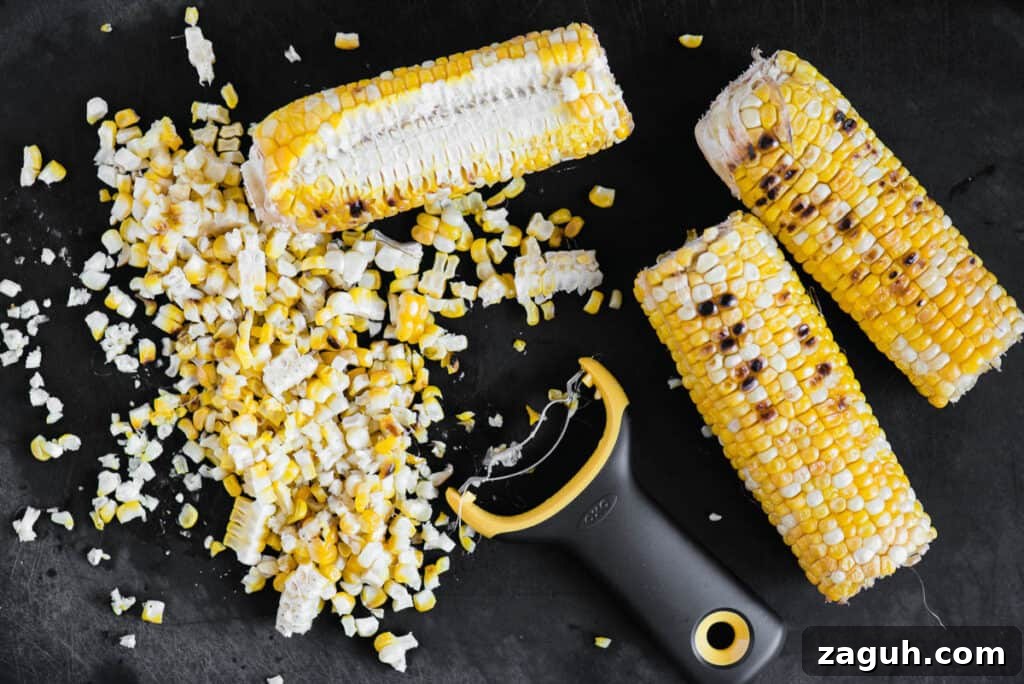 Crisp Summer Corn Salad with Cherry Tomatoes and Herbs 3 removing kernels of corn from the cob