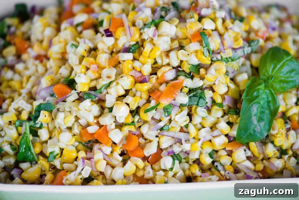 Crisp Summer Corn Salad with Cherry Tomatoes and Herbs 4 close up of grilled corn with onions, peppers, and basil