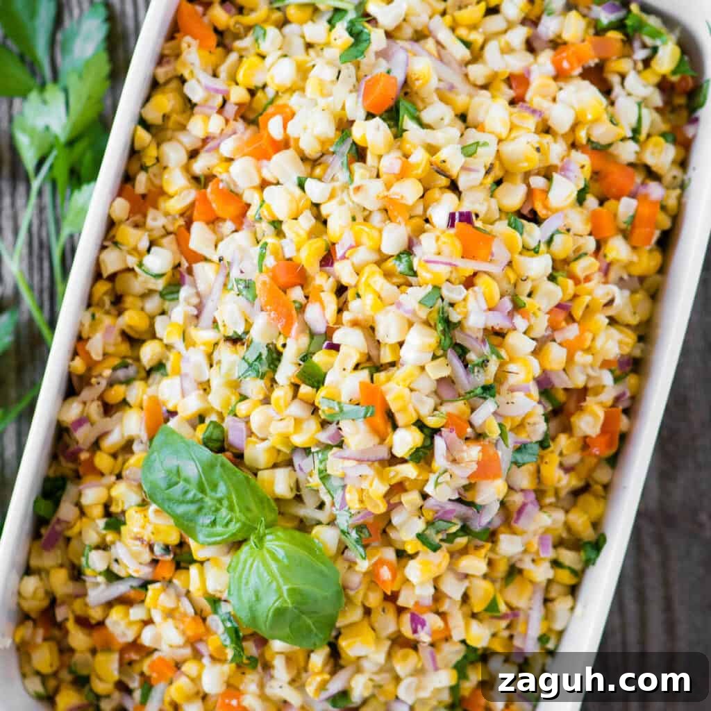 Crisp Summer Corn Salad with Cherry Tomatoes and Herbs 5 rectangle dish of vegetable salad with corn