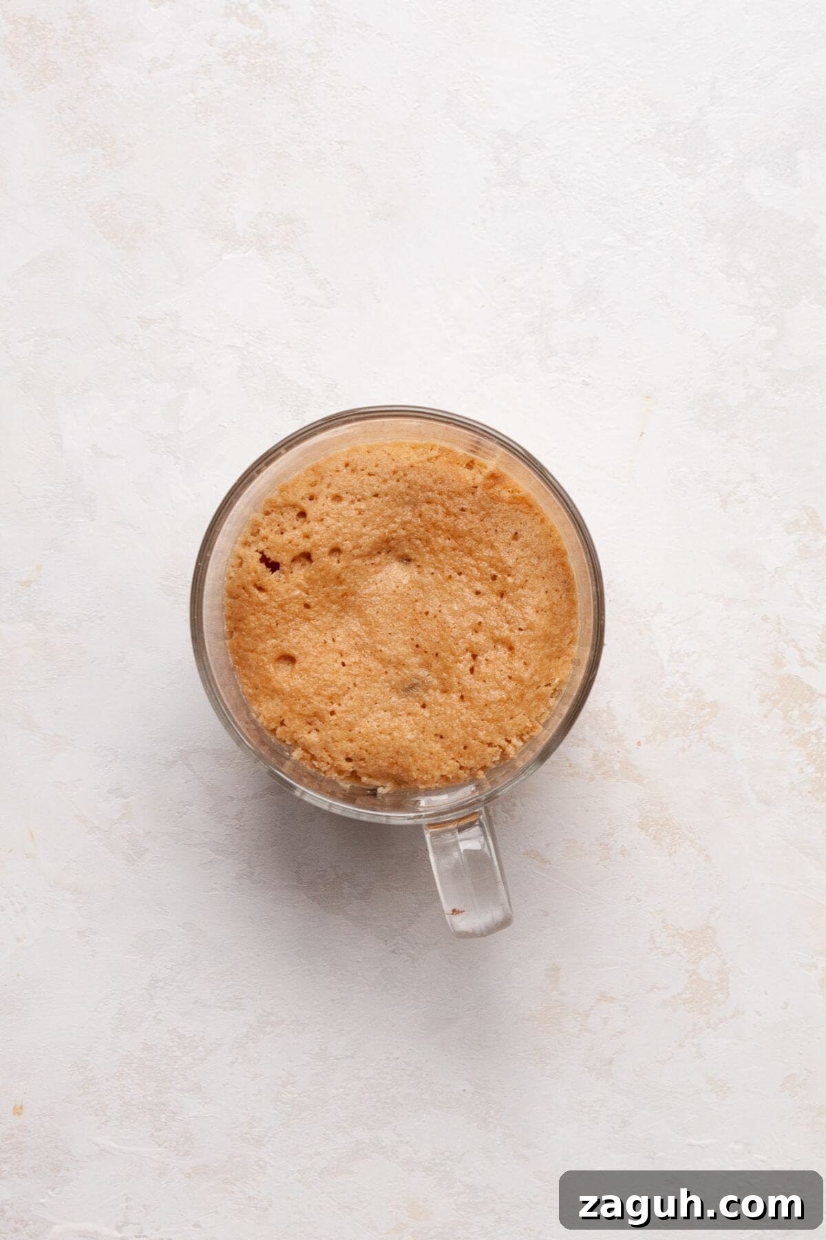 Protein Powder Mug Cake Recipe: Quick Single-Serve Treat 6 Fluffy protein mug cake after cooking in the microwave for 60 seconds.