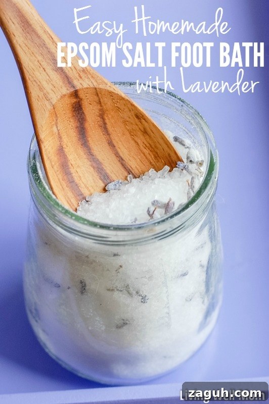 Lavender Epsom Salt Foot Soak Recipe for Relaxation 2 homemade lavender epsom salt foot bath in glass jar with wood spoon and purple background