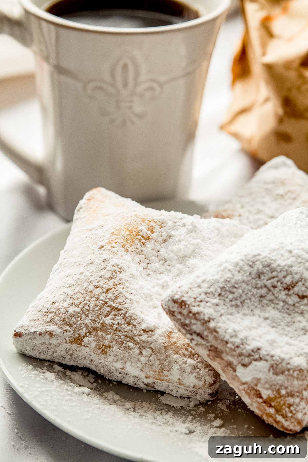 3 New Orleans style beignets on a plate.