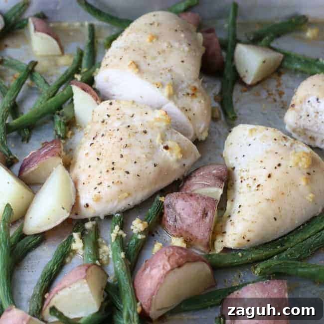 A plate of food, with Chicken potatoes and green beans.