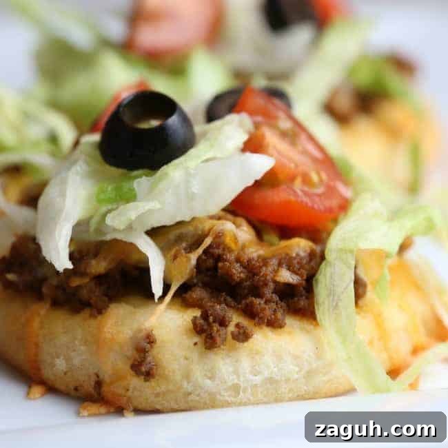 A close up of a plate of food with  Taco Pizza.