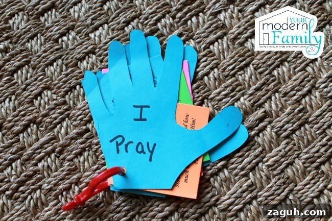 Paper hands with words written on them.
