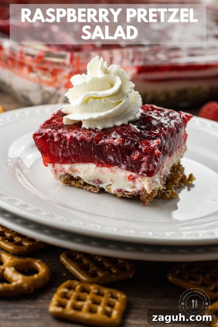 Creamy Raspberry Pretzel Salad with Sweet Cream Cheese Topping 7 slice of raspberry pretzel salad topped with whipped cream