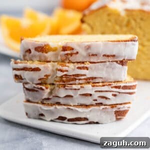 Moist Orange Pound Cake Recipe with Zesty Citrus Glaze 17 A stack of slices of orange pound cake topped with a glaze.