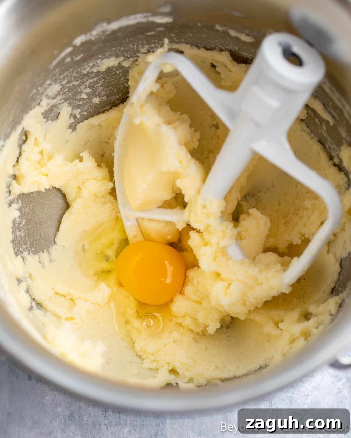 Moist Orange Pound Cake Recipe with Zesty Citrus Glaze 4 Mixing cake batter in a mixing bowl.