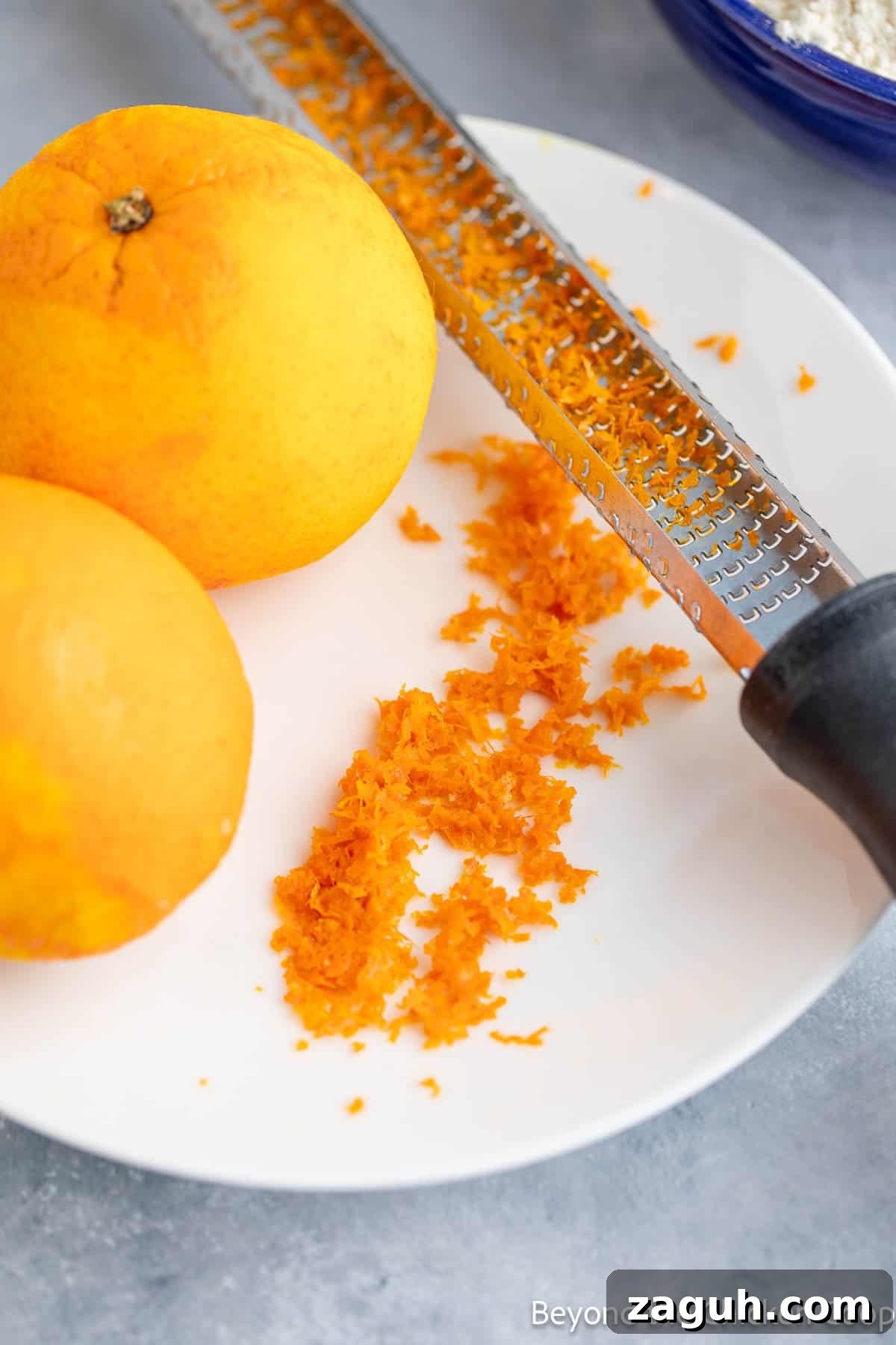 Moist Orange Pound Cake Recipe with Zesty Citrus Glaze 5 Zesting an orange with a zester.
