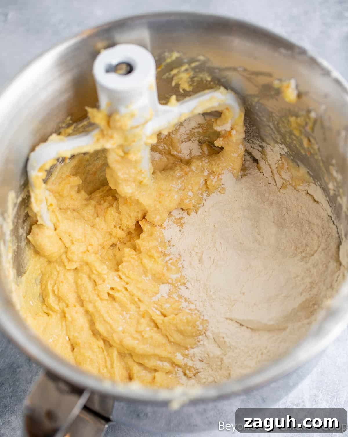 Moist Orange Pound Cake Recipe with Zesty Citrus Glaze 7 Adding flour to cake batter.