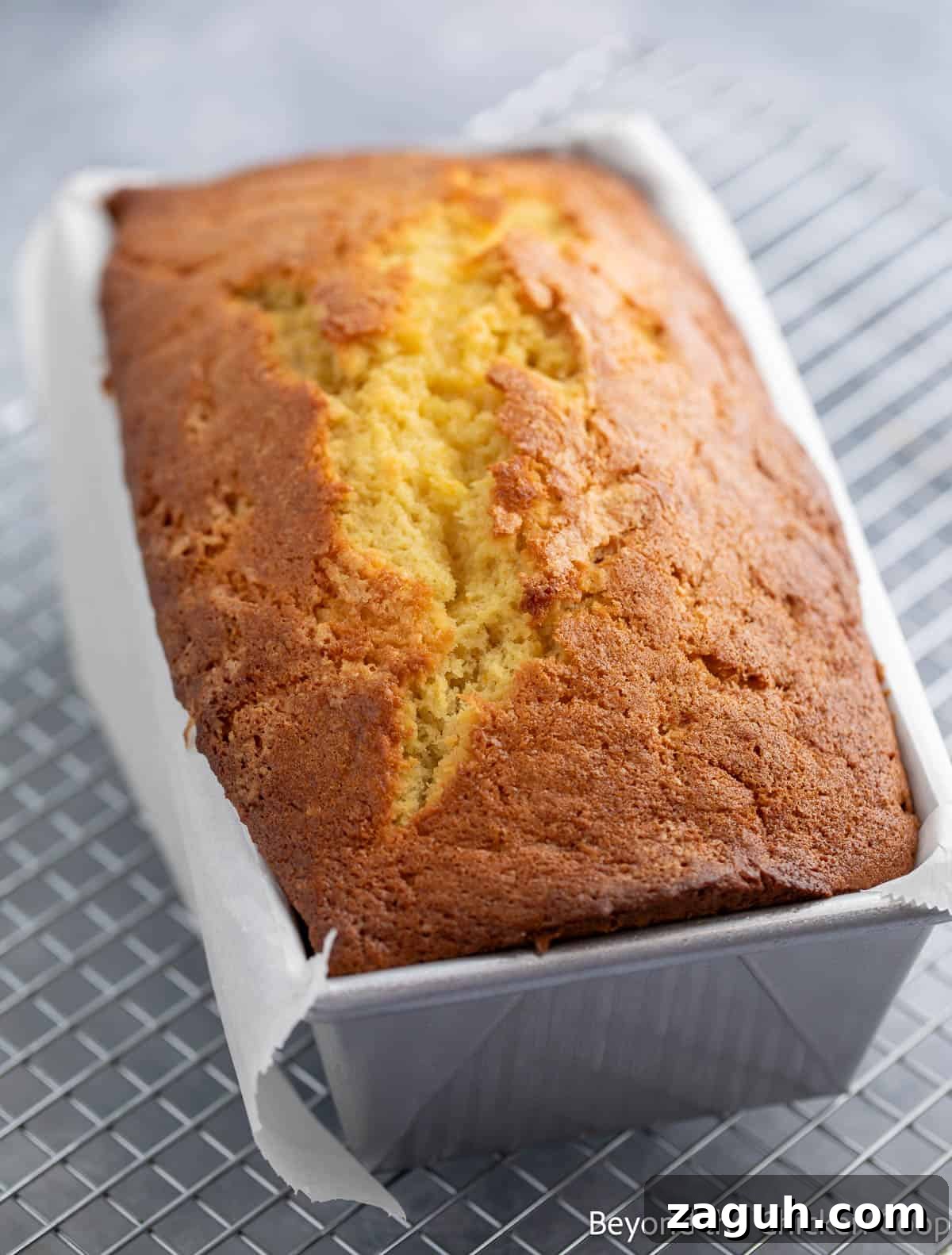 Moist Orange Pound Cake Recipe with Zesty Citrus Glaze 9 A baked pound cake in a loaf pan.