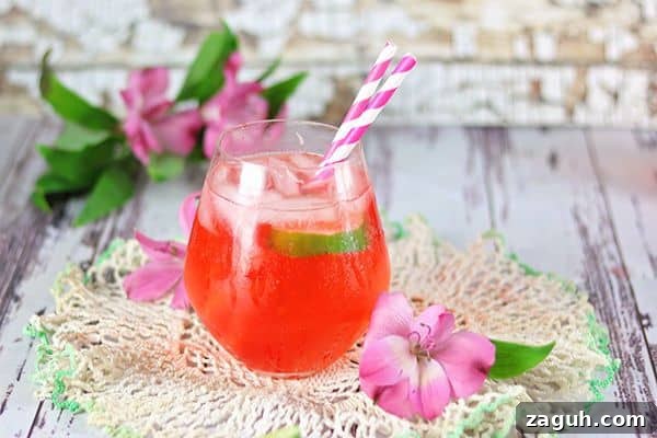 Dirty Shirley Cocktail Recipe with Vanilla Vodka — Adult Party Drink 3 A red cocktail is on a piece of lace and surrounded by pink flowers.