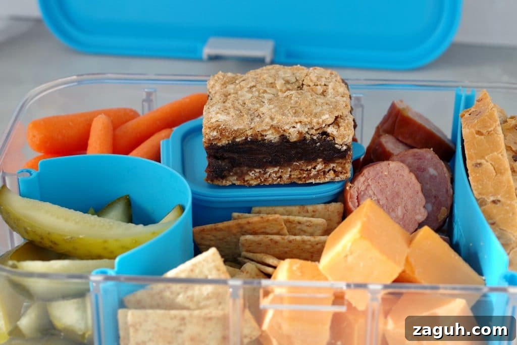 Filled Ukrainian Bento box with date square and bento box lid in background