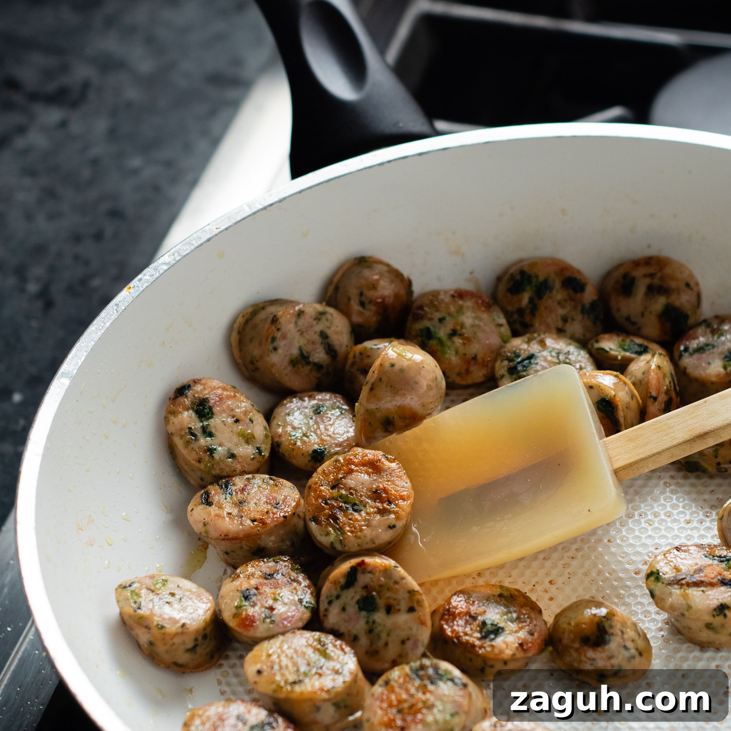 Quick Chicken Sausage Pesto Pasta with Spinach & Cherry Tomatoes 4 chicken sausage sauteing in a pan.