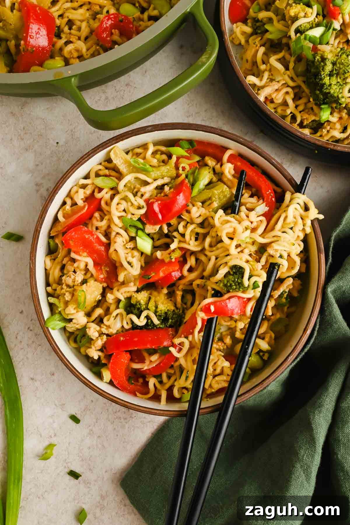 upgraded ramen with peppers, broccoli and edamame in serving bowl with black chopsticks.