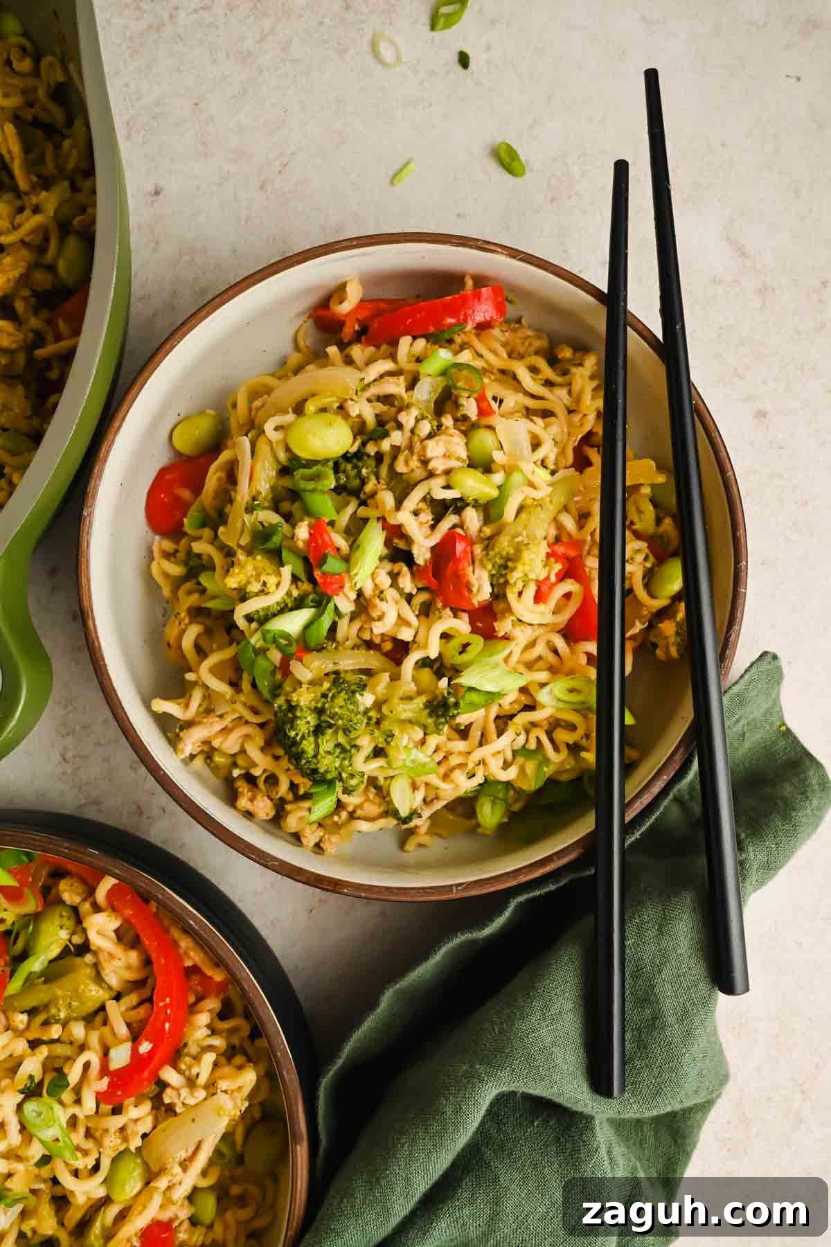 upgraded ramen with peppers, broccoli and edamame in serving bowl with black chopsticks.