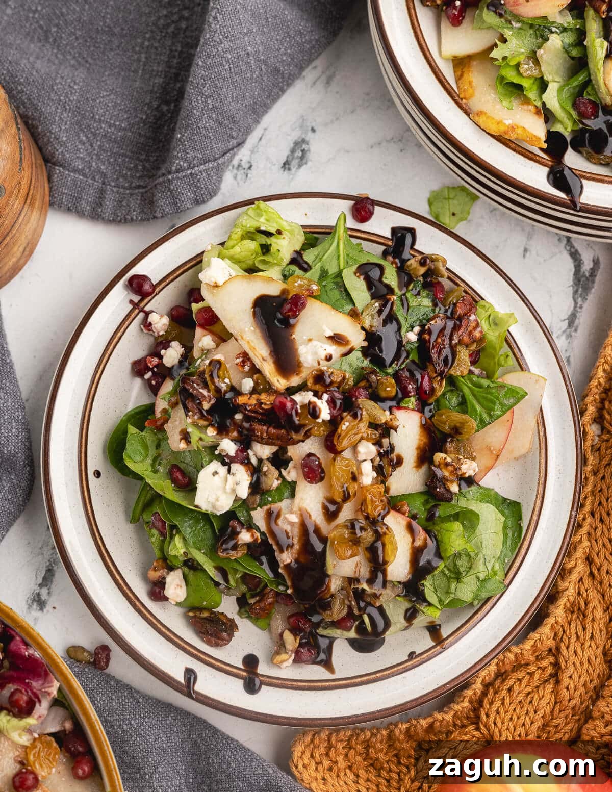 Pomegranate, Pear & Candied Pepita Salad with Citrus Vinaigrette 2 salad with pears, apples, pomegranate seeds, feta, and candied pepitas.