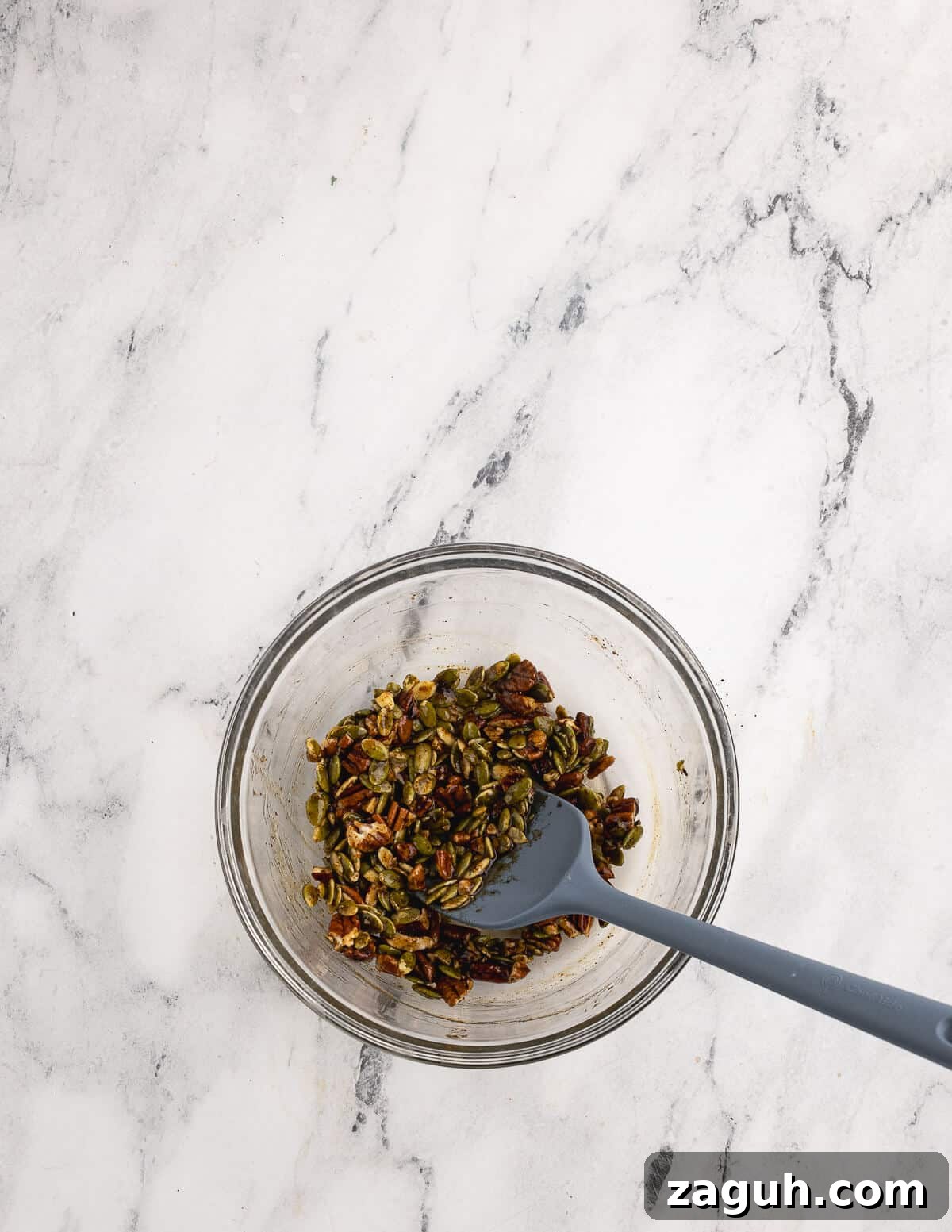 Pomegranate, Pear & Candied Pepita Salad with Citrus Vinaigrette 4 a bowl of pepitas, pecans, and sugar.