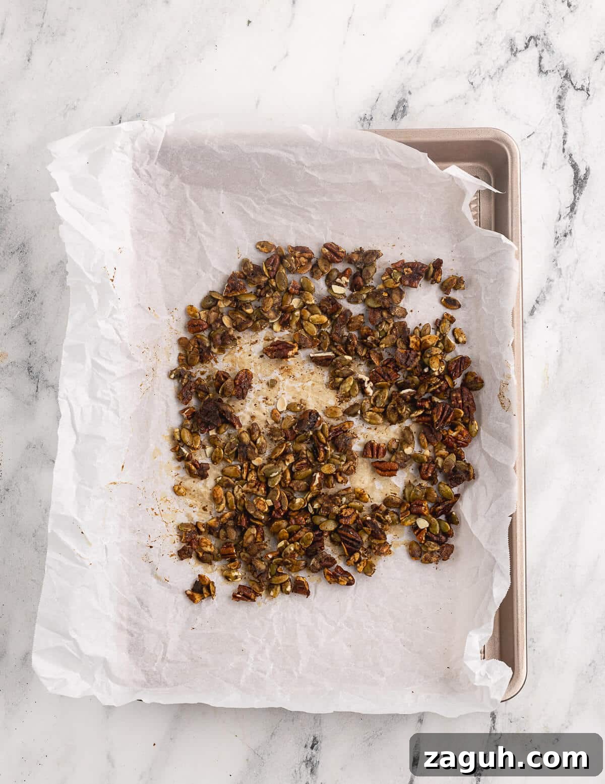 Pomegranate, Pear & Candied Pepita Salad with Citrus Vinaigrette 7 candied pepitas on a sheet pan.