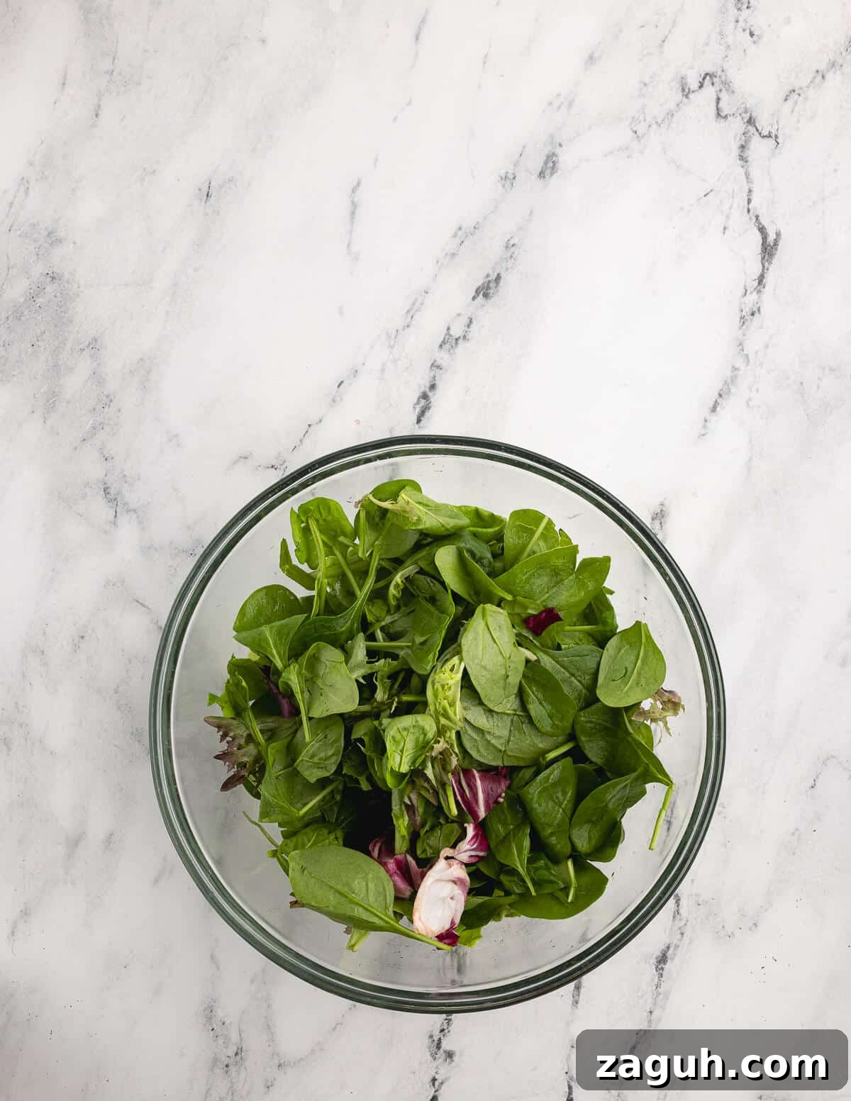 Pomegranate, Pear & Candied Pepita Salad with Citrus Vinaigrette 9 butter lettuce and mixed greens in a bowl.