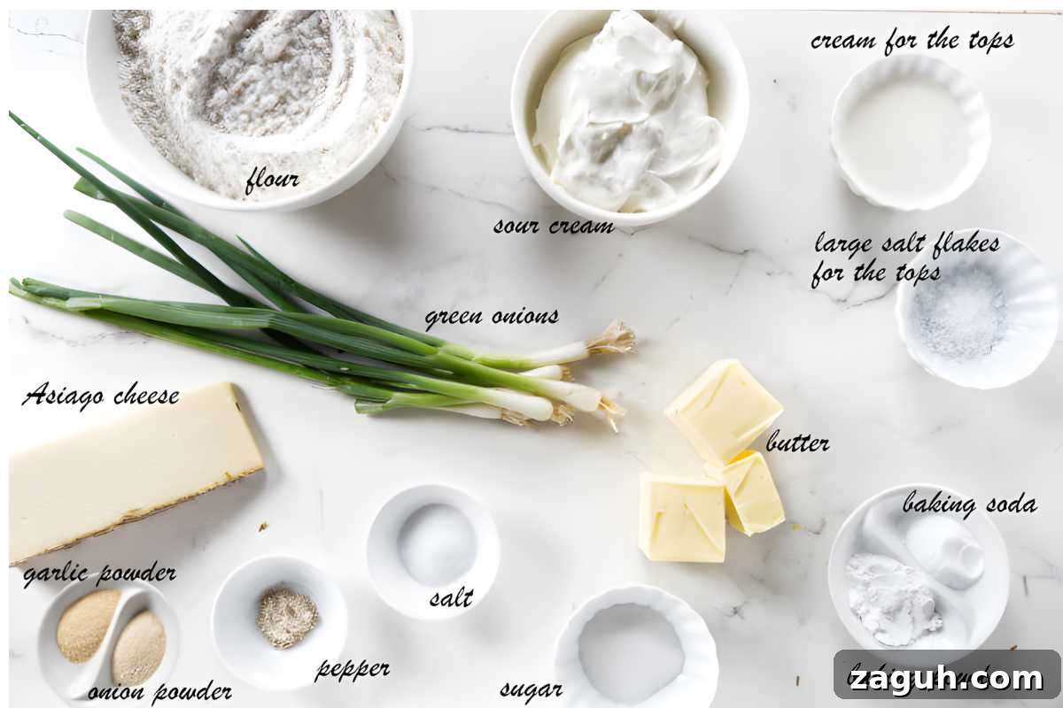 Recipe ingredients, including green onions and cheese, arranged on a white surface.