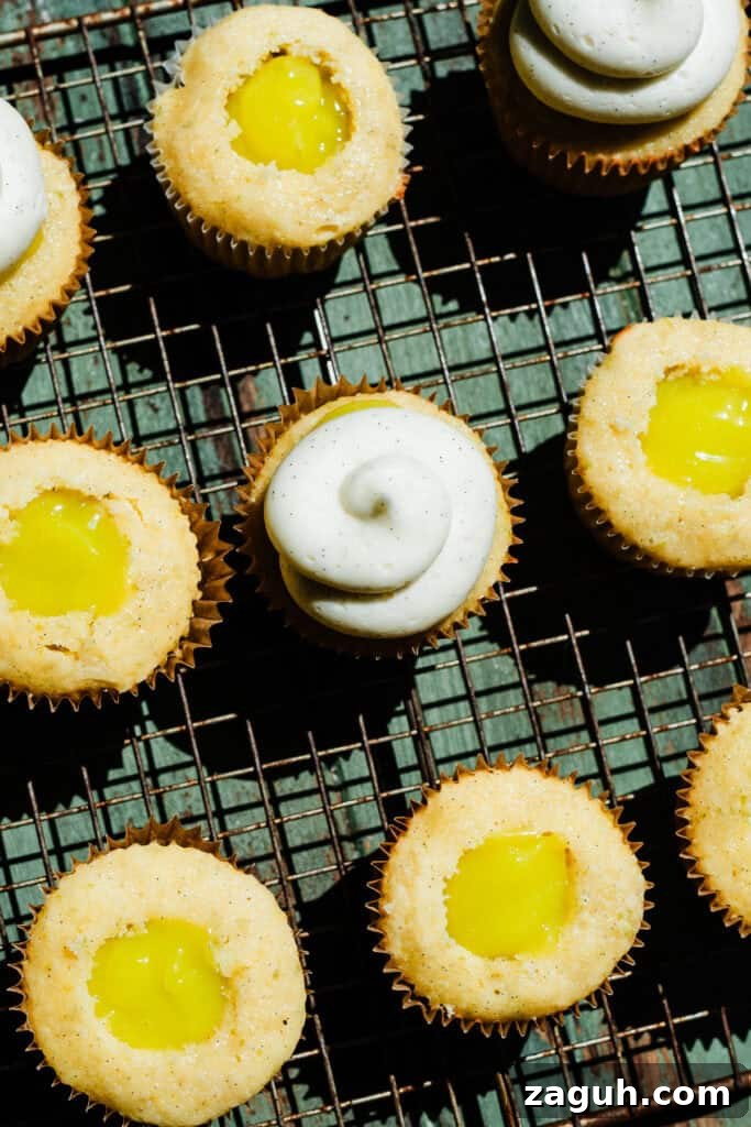 Key Lime Cupcakes with Tangy Lime Curd Filling 8 A bird's eye view of the cupcakes on a cooling rack, being cored, filled, and frosted.