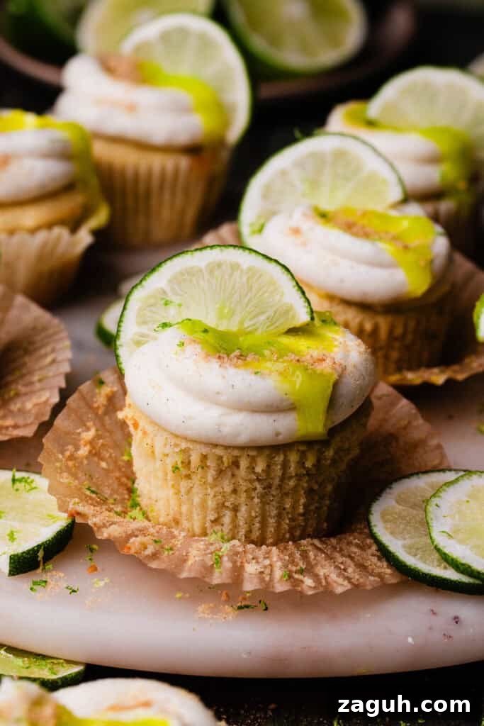 Key Lime Cupcakes with Tangy Lime Curd Filling 9 A close-up on a key lime cupcake with the wrapper peeled back.
