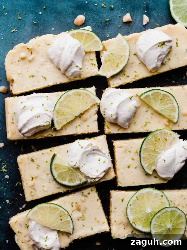 Key Lime Cupcakes with Tangy Lime Curd Filling 13 Key Lime Pie Bars on a blue background with dollops of whipped cream & lime slices.