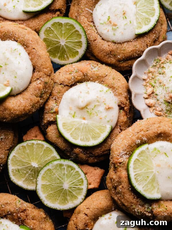 Key Lime Cupcakes with Tangy Lime Curd Filling 14 A close-up of the key lime pie cookies nestled together on a cooling rack, with slices of lime for garnish.