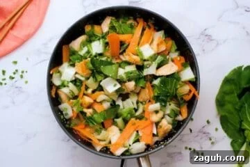 Chopped bok choy, carrot ribbons, and green onions added to browned chicken for quick and easy stir fry recipe.