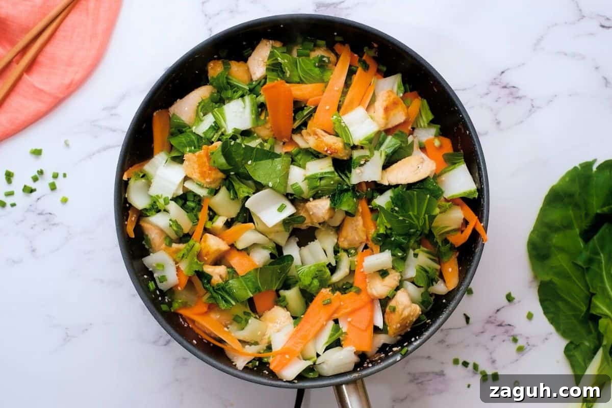 Chopped bok choy, carrot ribbons, and green onions added to browned chicken for quick and easy stir fry recipe.