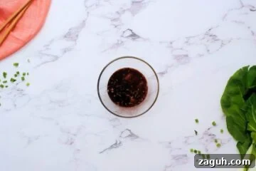 Soy sauce, honey, ginger, and garlic mixed together in small bowl for bok choy stir fry.