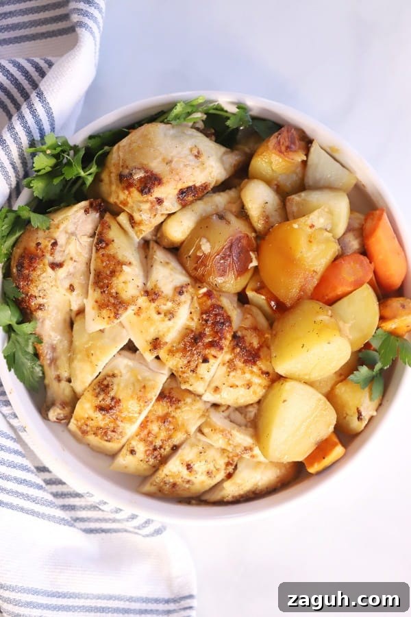 roasted chicken and potatoes and carrots in a large serving bowl.