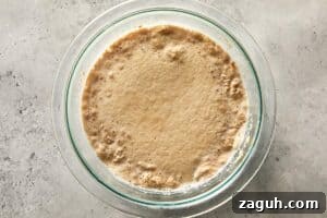 yeast activating in warm milk with bubbles forming on top