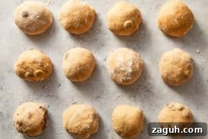 dough divided and shaped into balls arranged in baking tray