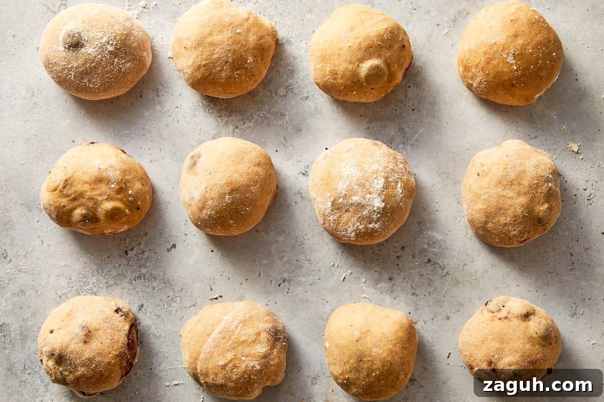 dough divided and shaped into balls arranged in baking tray