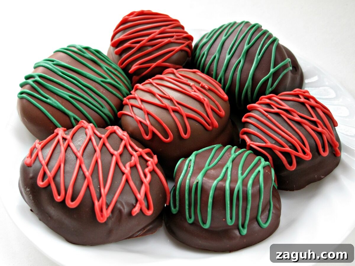 Chocolate Marshmallow (Mallomar) Cookies- This cookie is the first to be grabbed on holiday platters! A graham cracker base topped with a marshmallow and coated in chocolate. Drizzle with colors to match your holiday! | The Monday Box Chocolate Marshmallow (Mallomar) Cookies are coated in chocolate and have decorative red or green zigzags.