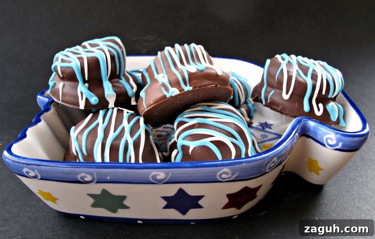 Chocolate Marshmallow (Mallomar) Cookies- This cookie is the first to be grabbed on holiday platters! A graham cracker base topped with a marshmallow and coated in chocolate. Drizzle with colors to match your holiday! | The Monday Box Copycat Mallomar cookies drizzled in blue and white for Hanukkah in a bowl.