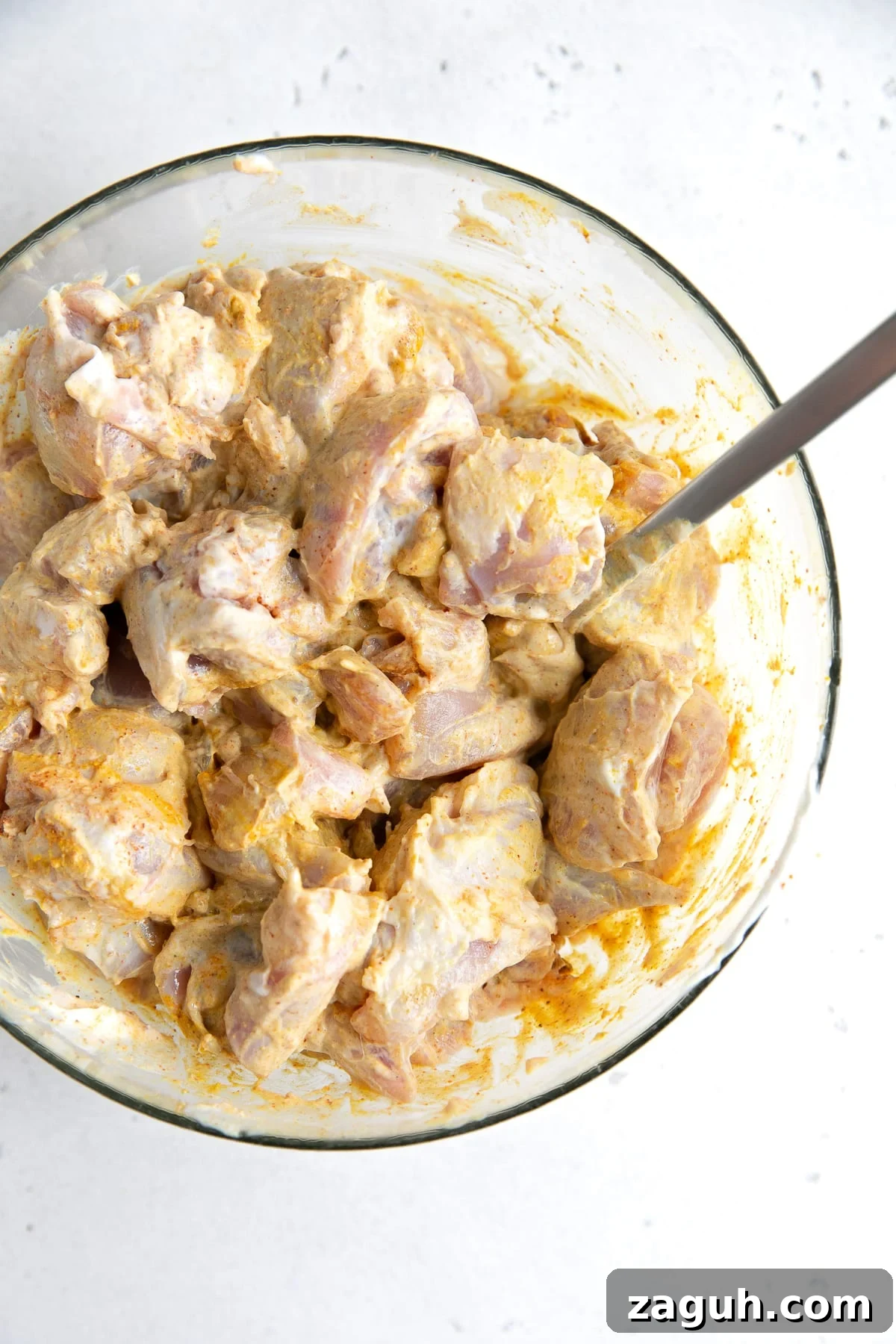 Authentic Chicken Curry Recipe: Step-by-Step Homemade Guide 5 Chunks of chicken thigh meat marinating in spiced yogurt.