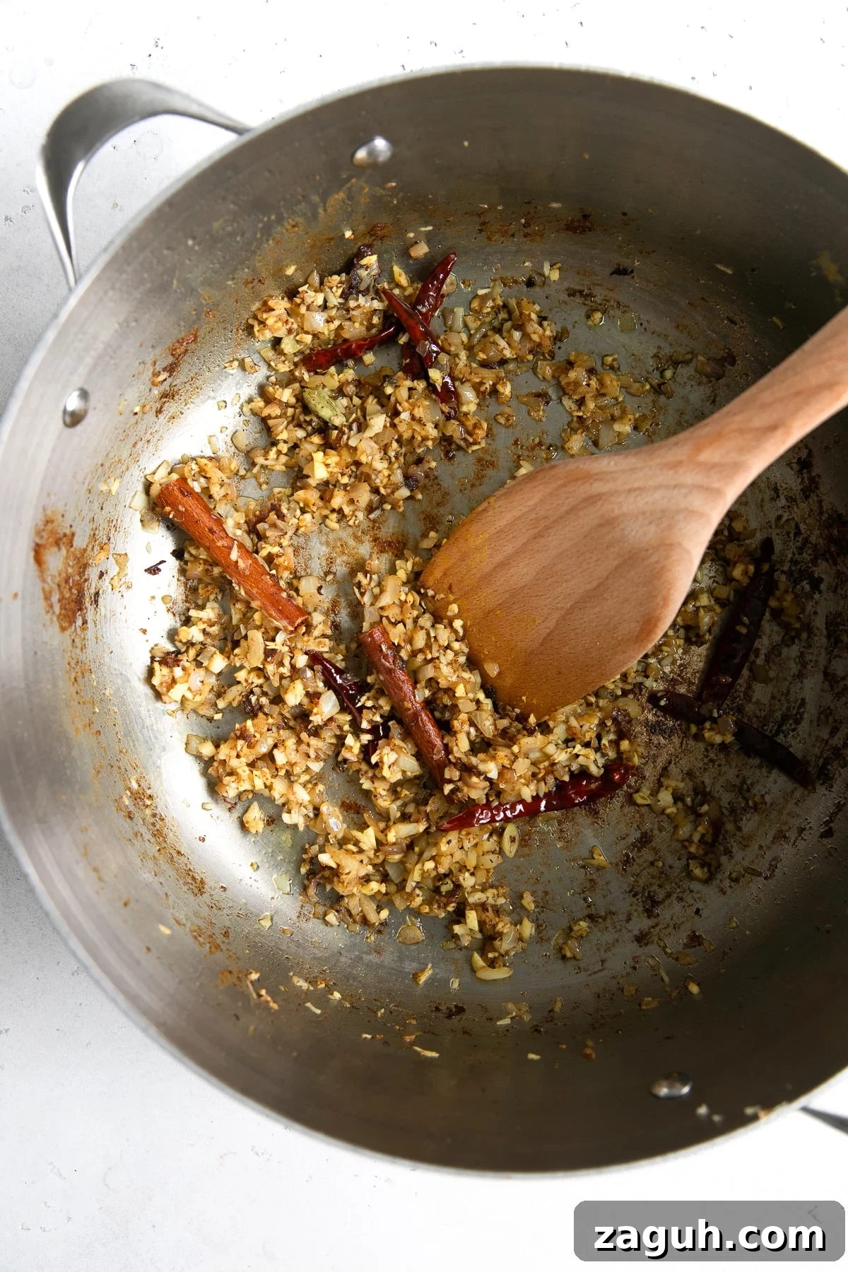 Authentic Chicken Curry Recipe: Step-by-Step Homemade Guide 6 Sautéing aromatics in a large heavy-bottomed skillet.