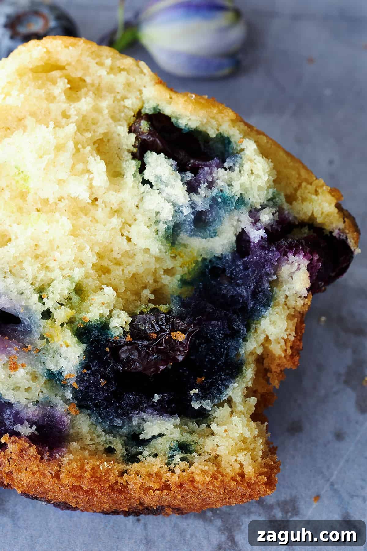 Starbucks-Style Blueberry Muffins Recipe: Make Them at Home 6 Half a Starbucks blueberry muffin, showing the soft fluffy center.