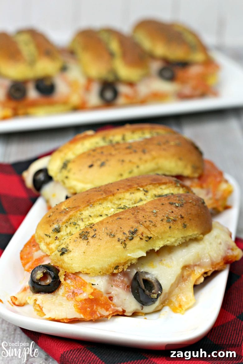 Sheet Pan Pepperoni Sliders Recipe — Quick Party Appetizer 3 Pepperoni Pizza Sliders On Plate