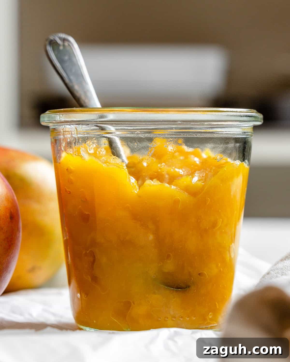 3-Ingredient Mango Compote (Simple Coulis Recipe) 10 completed mango compote in a jar against a light background