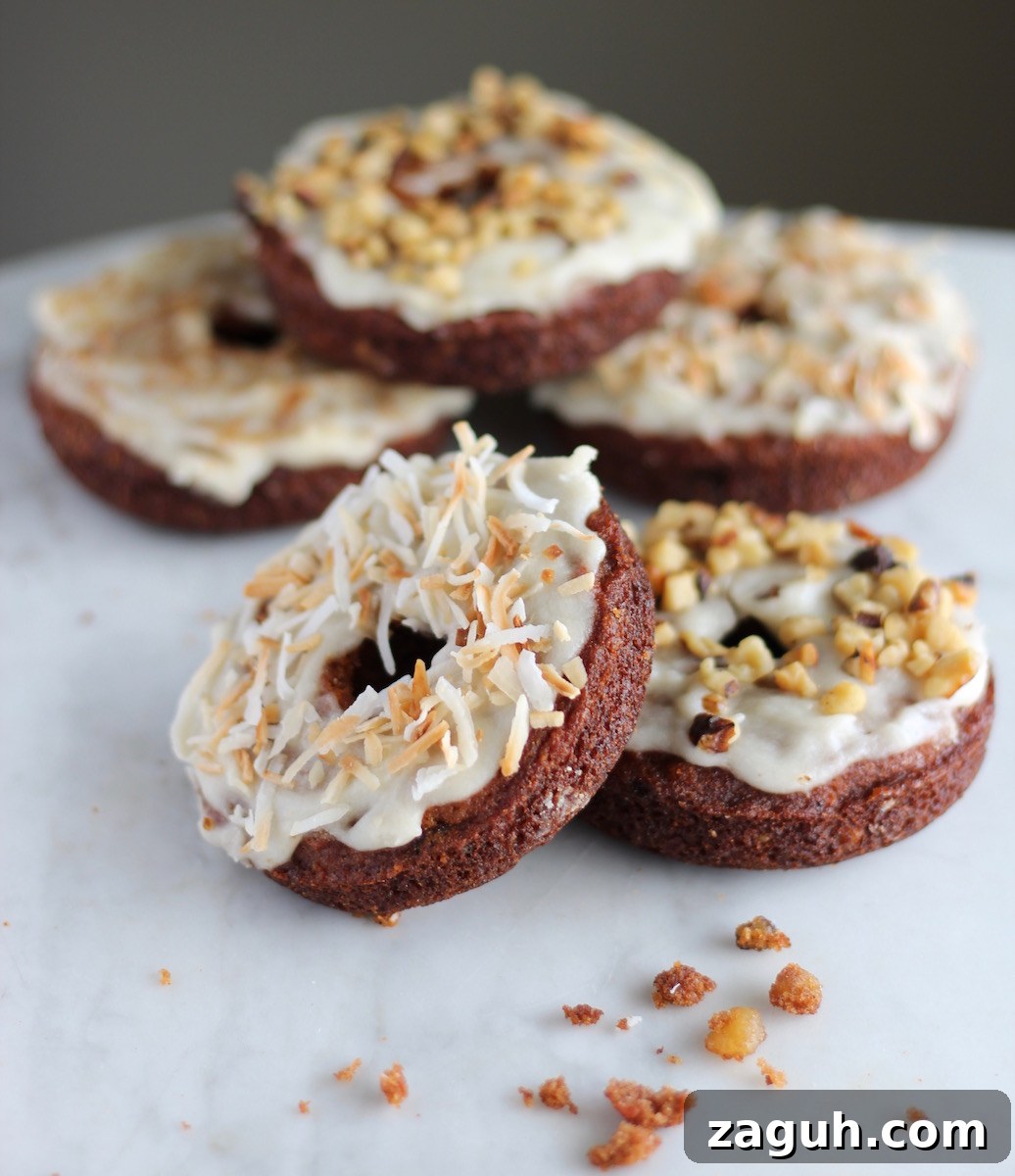 Paleo Carrot Cake Donuts - a delicious combination of baked carrot cake smothered in coconut butter glaze! Your family will LOVE these! | fedandfulfilled.com